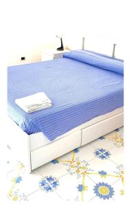 a bed with a blue and white bed frame at VILLA AZZURRA in Gaeta