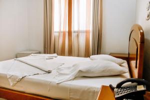 Hotel Agosto Neto客房内的一张或多张床位