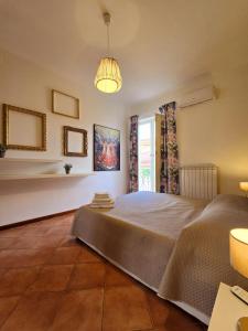 a bedroom with a large bed and a window at Il Balconcino in Caserta