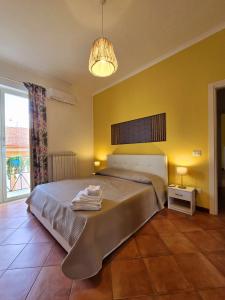 a bedroom with a bed with towels on it at Il Balconcino in Caserta +31 photos