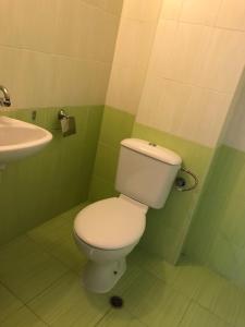 a bathroom with a white toilet and a sink at апартамент CITY HOME 22 in Yambol +33 photos