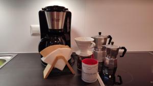a counter top with a coffee maker and other kitchen items at Ferienwohnung Trifts l Wallbox l Parkplatz l AusZeit Card in Wangen im Allgäu