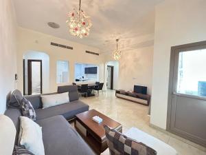 a living room with a couch and a table at Al Hayat Suites Apartment in Manama