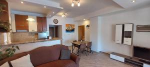 a living room with a couch and a kitchen with a table at Adriatic - Apartment with jacuzzi in Sobra