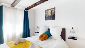 a bedroom with an elephant picture on the wall at Triplex Le Bel Âtre in Sélestat +8 photos