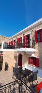 a patio with a table and chairs in front of a building at VILLA ELENA in Halki