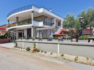 a large white building with plants on the side of it at Elea Studios by Booking Kottas in Olynthos