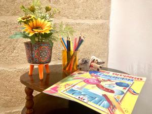 un tavolo con un libro e un vaso di fiori di Antica Pietra a Polignano a Mare