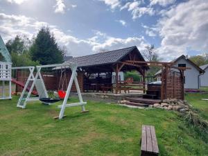 a gazebo with a playground in a yard at Rodzinna Przystań in Lubawka