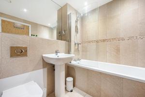 a bathroom with a sink and a bath tub at The Railway Pass The Keys Modern 2-Bed Apartment in Central Altrincham in Altrincham +13 photos