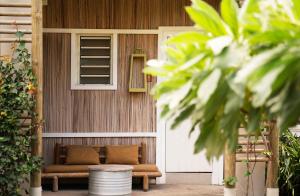 a porch with a bench in front of a building at Veranda Tamarin Hotel & Spa in Tamarin
