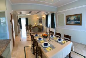 a dining room with a table and chairs at A&B Ialysos villas and apartments in Ialysos