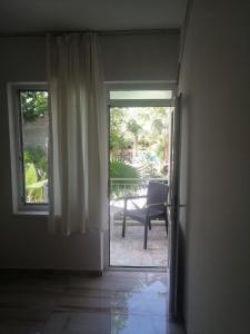 an open door to a patio with a chair outside at Kiriş Banana Suit in Kemer