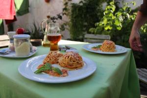 zwei Teller Spaghetti auf dem Tisch mit einem Glas Bier in der Unterkunft Hotel u Budvaru in Budweis