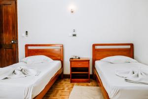 Hotel Agosto Neto客房内的一张或多张床位