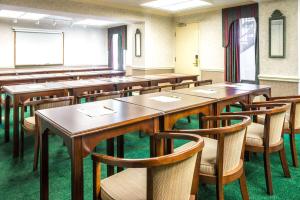 a classroom with wooden tables and chairs and a chalkboard at Days Inn by Wyndham Salem in Salem