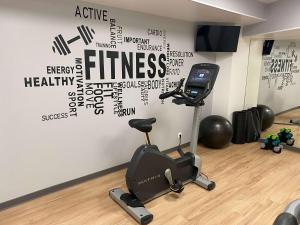 a room with a treadmill and a wall with words on it at Mercure Epinal Centre in Épinal