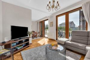 a living room with a couch and a television at Villa Markota!200m from the SEA! - Makarska Exklusiv in Promajna