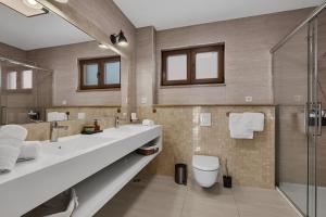 a bathroom with two sinks and a toilet and a shower at Villa Markota!200m from the SEA! - Makarska Exklusiv in Promajna +18 photos