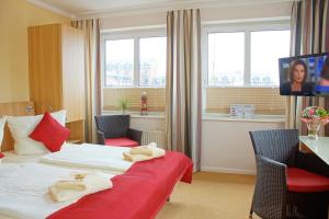 ein Hotelzimmer mit einem Bett mit Handtüchern darauf in der Unterkunft Baltic Kölln Hotel in Heiligenhafen