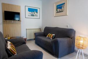 sala de estar con sofá y silla en Apartamentos - Solar Vale Covo, en Carvoeiro