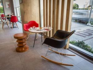 - une table et des chaises dans une chambre avec fenêtre dans l'établissement Ibis Istanbul West, à Istanbul
