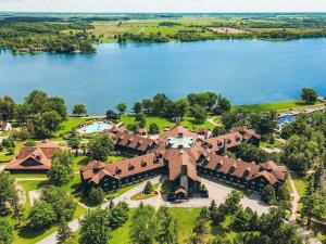 an aerial view of a house with a lake at Fairmont Le Chateau Montebello in Montebello