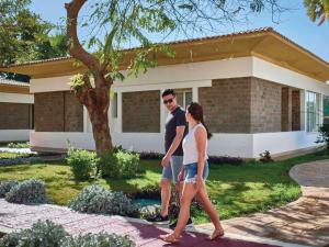 a man and a woman walking in front of a house at Mövenpick Resort Aswan in Aswan