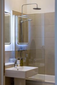 a bathroom with a sink and a shower at 28 York Place Hotel in Edinburgh