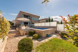 a house with a swimming pool in a yard at Villa Lantana ZadarVillas in Petrcane