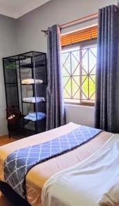 Schlafzimmer mit einem Bett und einem Fenster in der Unterkunft Horizon heights 2 in Kira