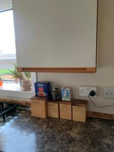 a room with boxes and a whiteboard and a window at Kings St View Simple Apartment in Aberdeen +15 photos