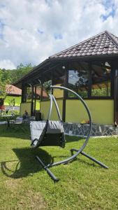 a swing in the grass next to a gazebo at Vila Drumetului in Comarnic