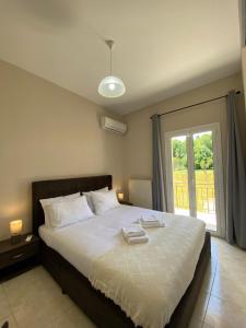 a bedroom with a bed with two towels on it at La vita e Bella Apartments by Corfuescapes in Kontokali