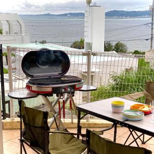 a grill sitting on top of a table on a balcony at  M’sOceanⅡ Uruma in Uruma