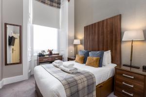 a bedroom with a large bed with towels on it at 28 York Place Hotel in Edinburgh