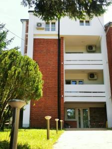 a building with a row of poles in front of it at Vila Breza in Soko Banja