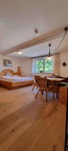 a large bedroom with a bed and a table at Serner am See in Zell am Moos