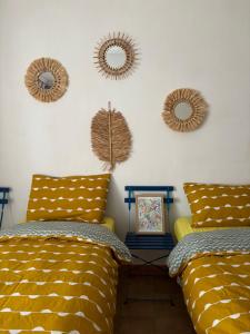 2 camas en una habitación con espejos en la pared en Casa Violetta, en Lotzorai