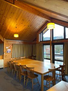 a dining room with a large wooden table and chairs at Dakune Chill - The Lodge in Ohakune