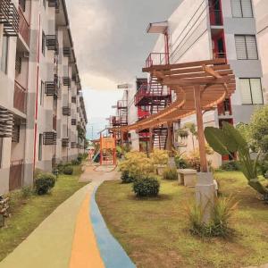 a walkway in the middle of a city with buildings at Rics Staycation at Urban Deca Homes Marilao, Bulacan in Marilao