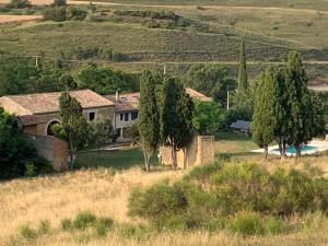 a house in the middle of a field with trees at Villa Kiener in Villeneuve-la-Comptal