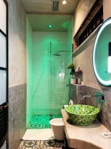 a bathroom with a shower with a bowl on the sink at Meri Boutique Hotel in Korçë
