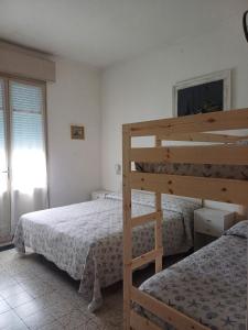 a bedroom with two bunk beds and a ladder at Hotel Flora in Cesenatico