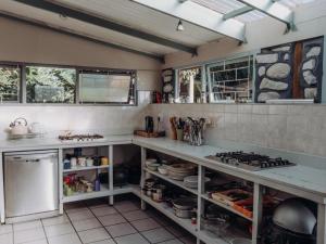 a kitchen with a counter and a stove top oven at Firefly Falls in Plettenberg Bay