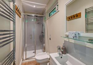 a bathroom with a shower and a toilet and a sink at City to Country Retreat Luxury Lodges with Hot Tub, BBQ, Fire Pit in Toppesfield +54 photos