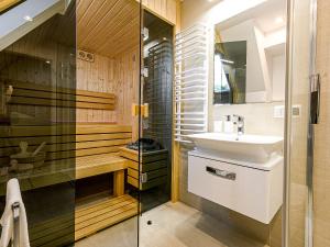 uma casa de banho com um lavatório e um chuveiro em VisitZakopane - Chalet Ski Apartment em Zakopane