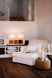 a living room with a white couch and a fireplace at La Farm Baleares in Santa Maria del Camí