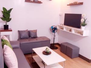 a living room with a couch and a table at Rics Staycation at Urban Deca Homes Marilao, Bulacan in Marilao