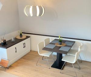 a dining room with a table and chairs at Appartement Backbord in Morsum